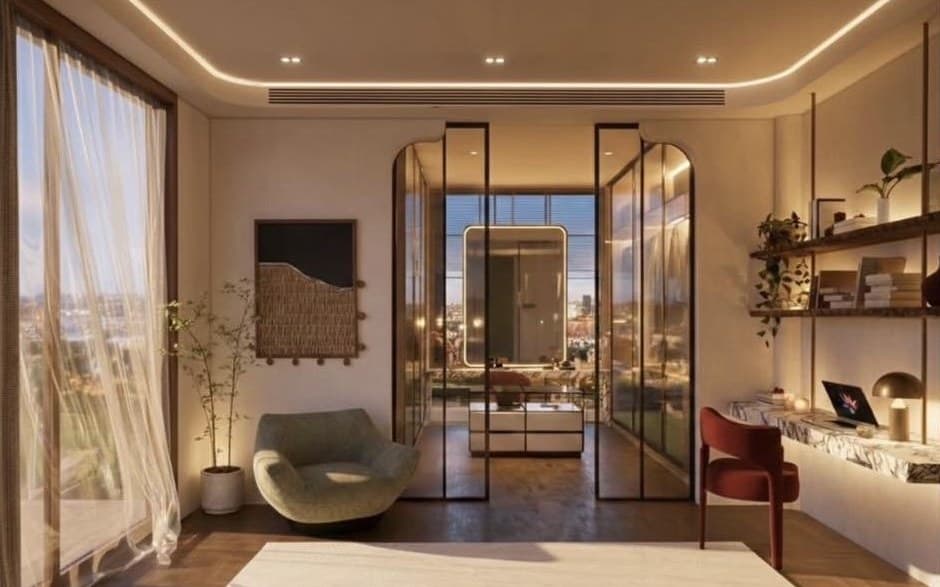 Bedroom and study with tall curtained windows, a sage lounge chair, arched black-framed glass doors and a floating marble desk, in warm evening light.